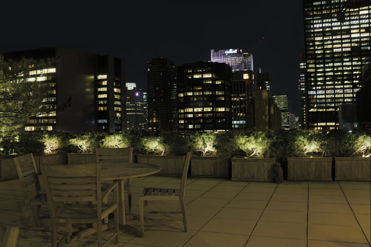 Terrace lighting with Manhattan skyline — outdoor lighting on NYC rooftop with city skyline in background