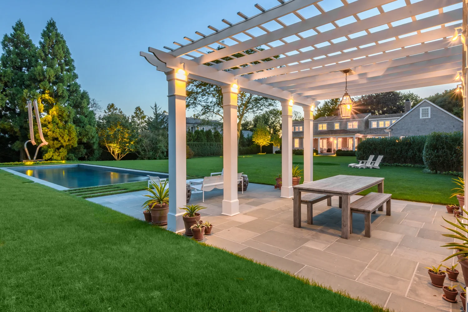 Tree canopy lighting at Southampton estate — uplighting illuminating mature tree canopy at night