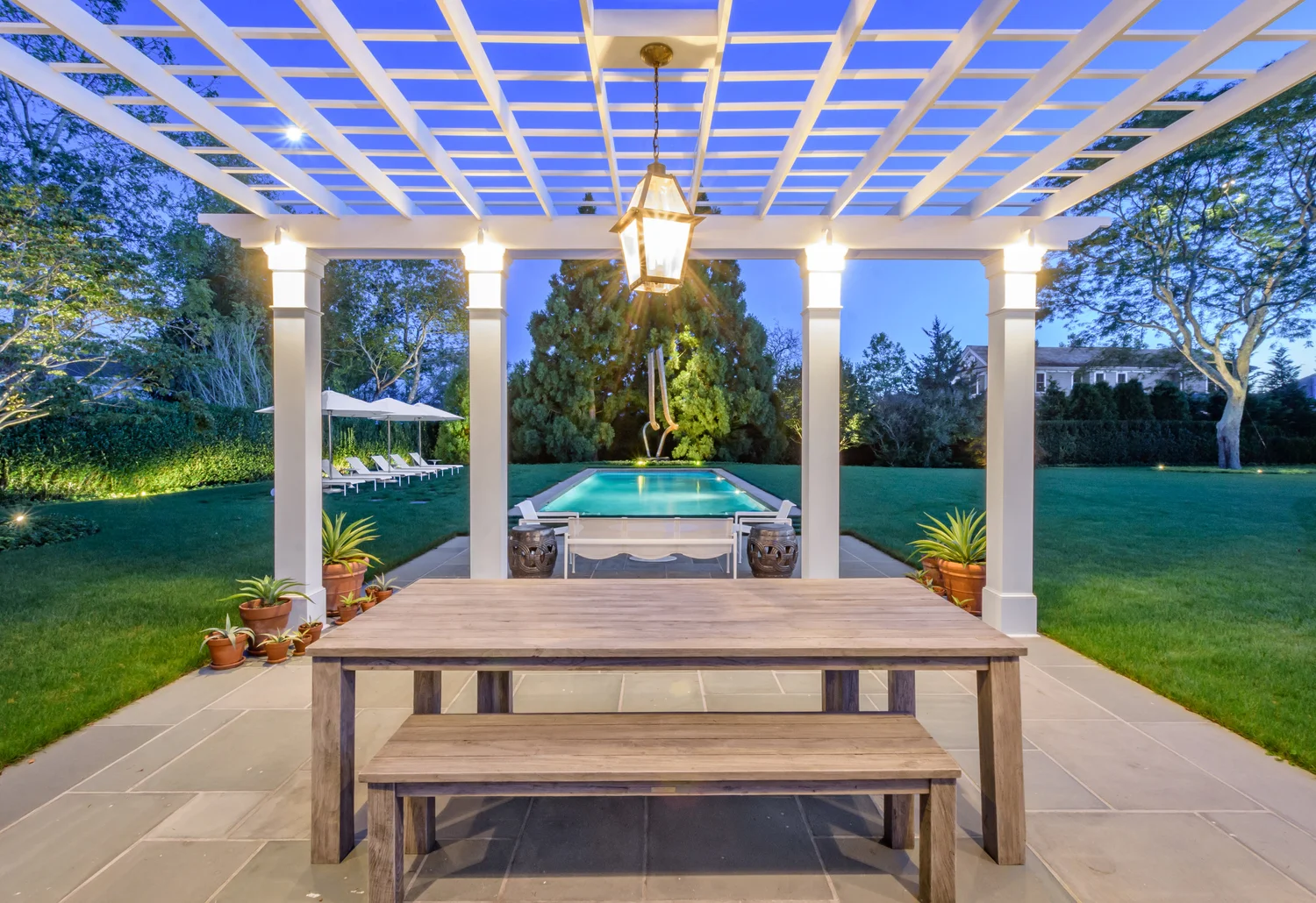Night atmosphere at Southampton Hamptons estate — atmospheric landscape lighting creating depth and drama