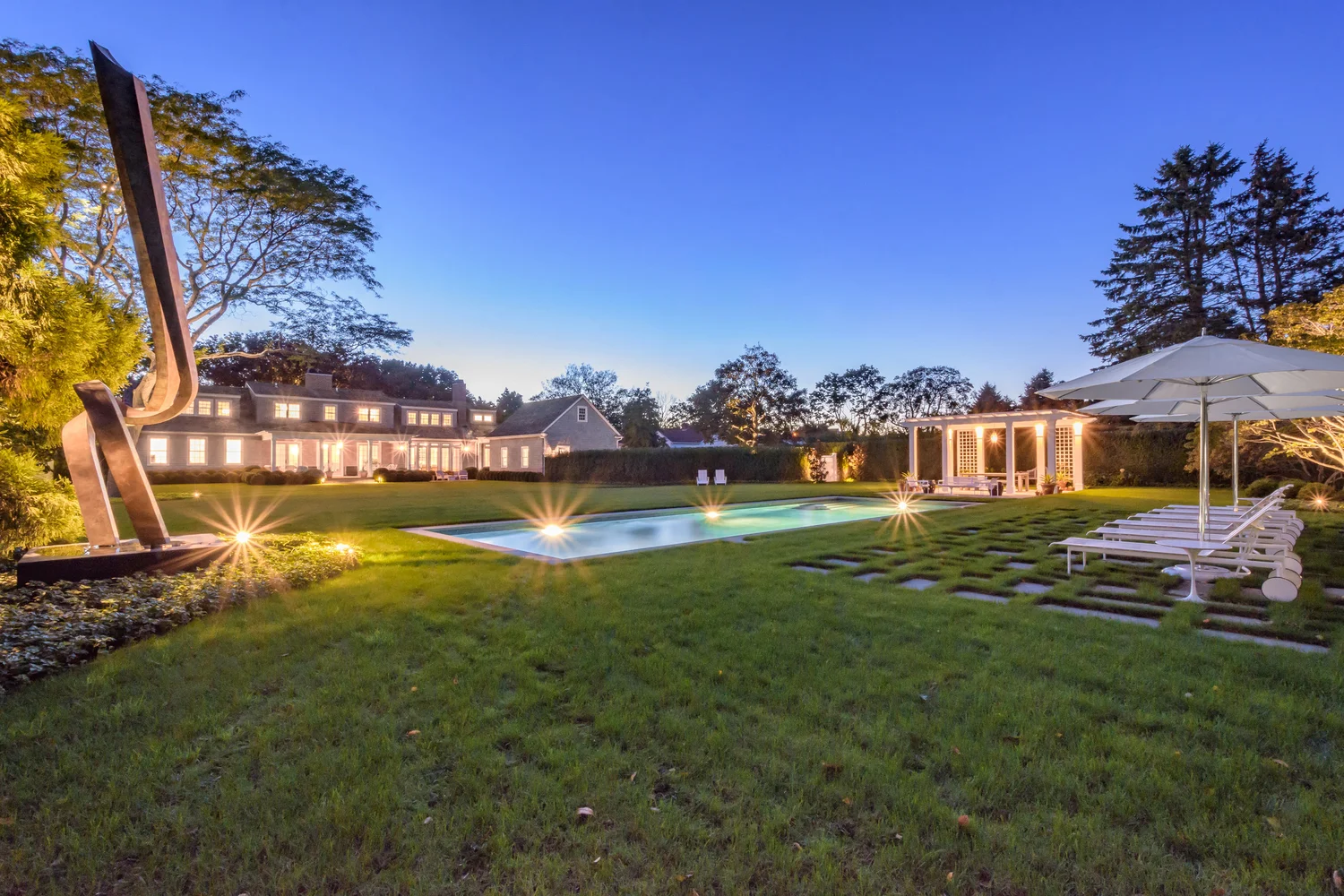 Grounds lighting at Southampton estate — wide view of lit landscape across Southampton property