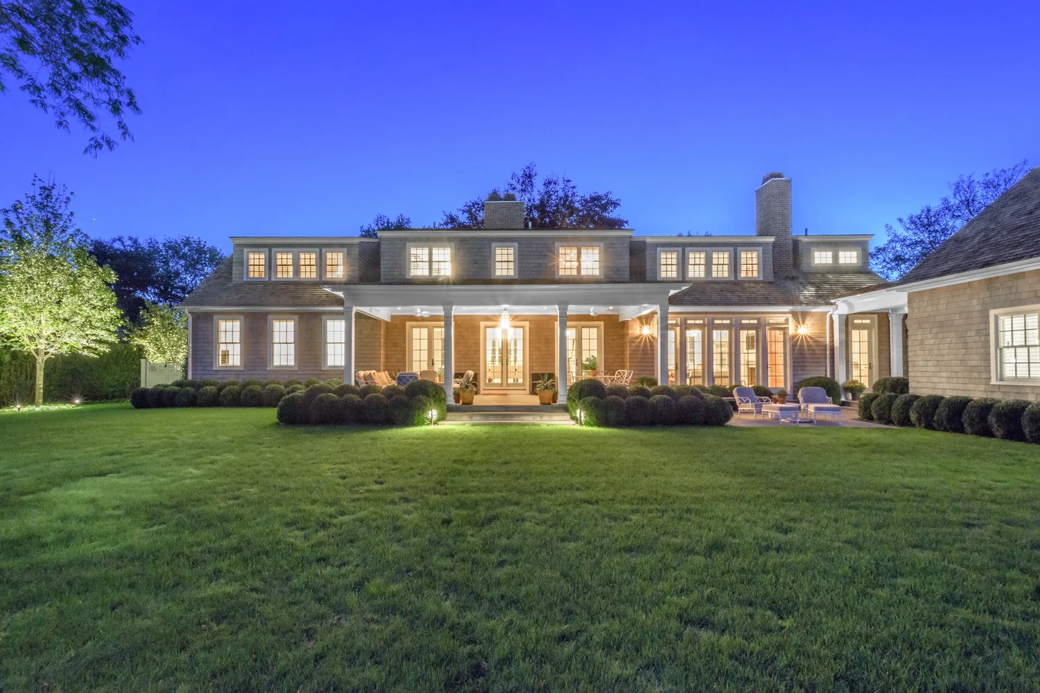 Garden at night at Southampton Hamptons property — outdoor lighting across formal garden design