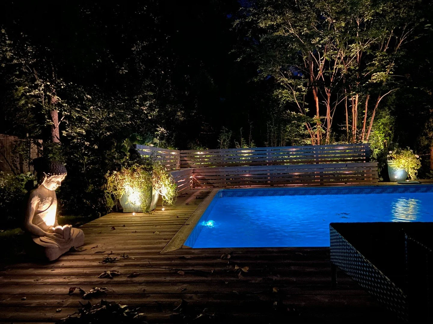 The trick to a backyard that feels like somewhere you'd book a room is not more light. It's better light.

Layered uplighting on the architecture, soft accent washes through the planting beds, a discreet glow at the water's edge &mdash; each one doin