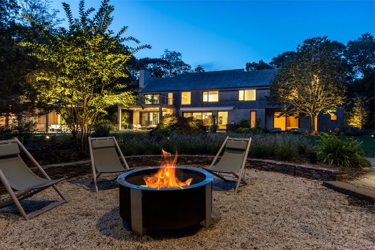 Outdoor lighting detail at Amagansett landscape project — fixture illuminating garden planting at night