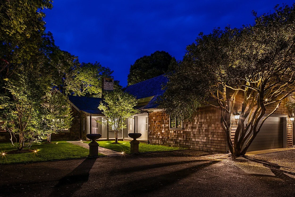 Night garden lighting at Amagansett luxury estate — layered landscape illumination