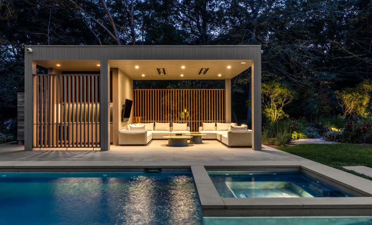 Landscape glow at Amagansett property — warm outdoor lighting illuminating garden and pathways