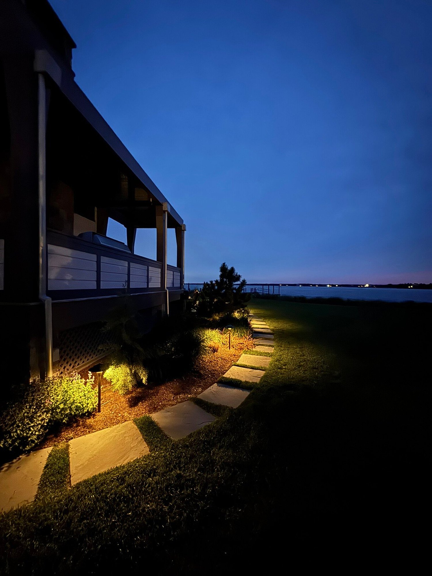 View of Lighting the Arrival For A Coastal Escape With Hamptons Landscape ...
