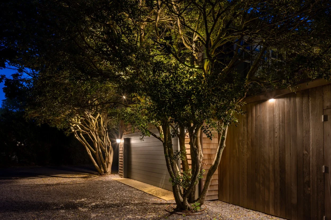 Evening vista at Amagansett Hamptons property — wide view of outdoor lighting installation
