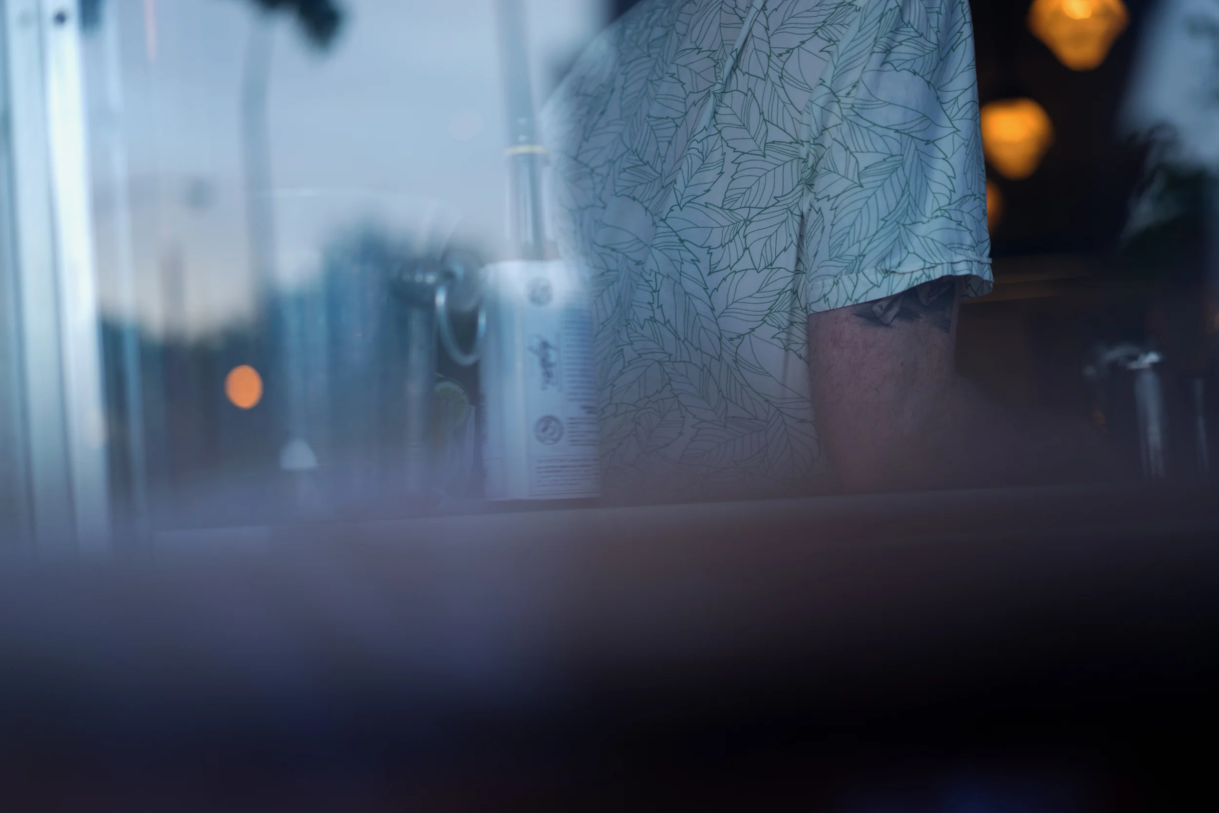 Pleasantly surprised with this shot from a restaurant's patio looking through a window at the bartender. f/1.8, 1/60th shutter, ISO 160.