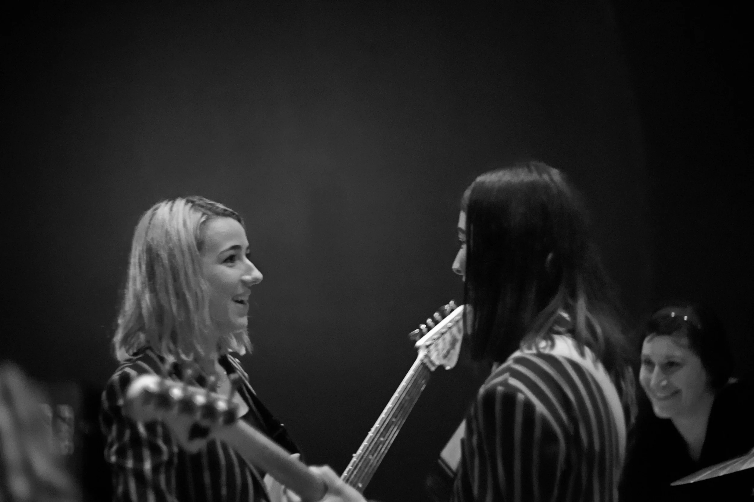 Favorite shot of the night. I like the subtlety of the light coming off the wall behind them. And all three of them look so sincerely happy and unaffected, like they forgot they were onstage in front of an audience. Shutter 1/50, f/1.5, ISO: 1000.