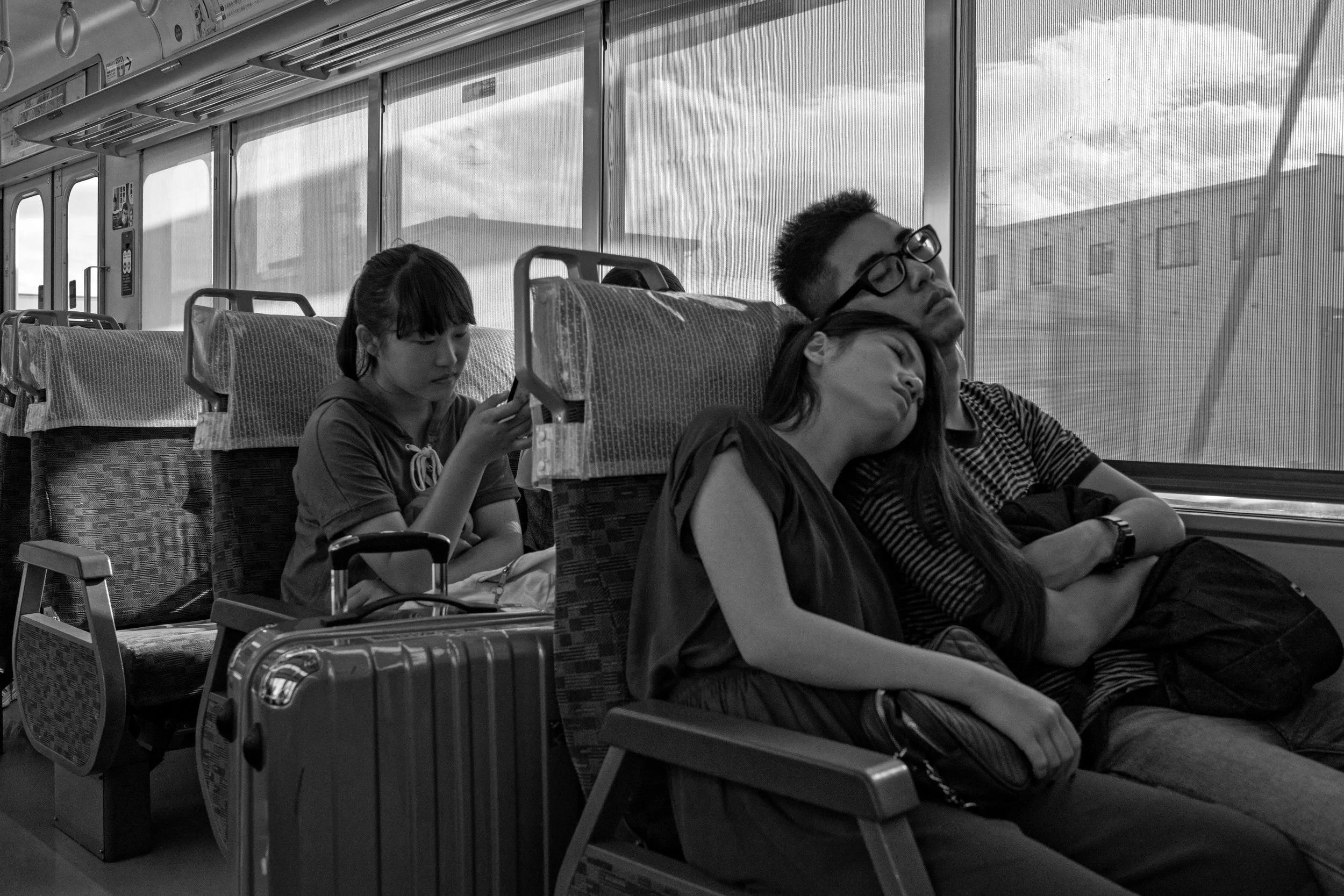 This was on a train from Nara to Kyoto. Obviously this one is more a matter of content than anything special photographically -- I might've been just as happy with a phone photo of the moment. I always feel self-conscious taking shots like this. That raises the question: Is it creepier to overtly grab shots like this with a big lens like the Distagon, or to be stealthy about it with something smaller? Shutter: 1/250th, f/6.3, ISO: 500.