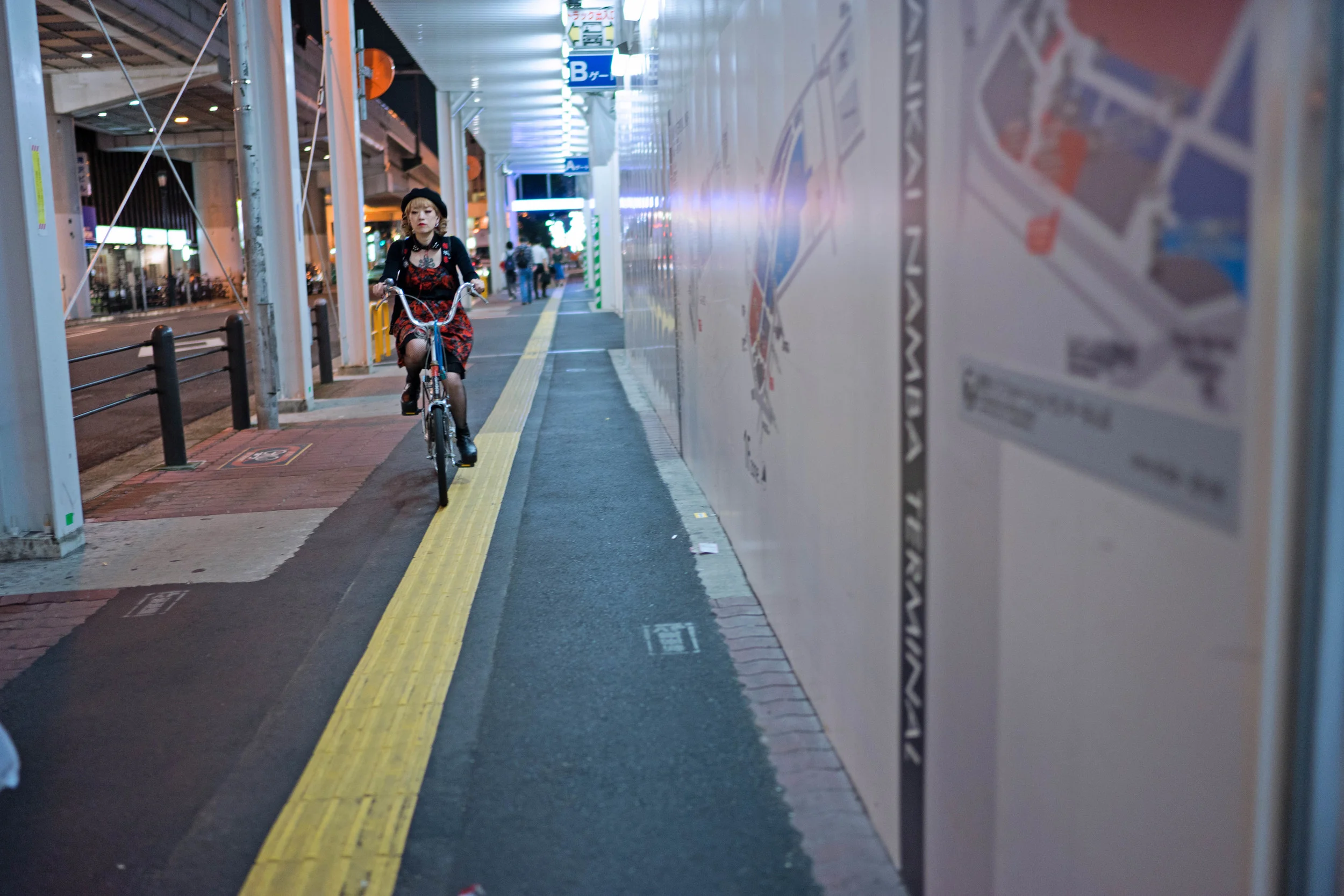 Another from Osaka, also wide open. There's a lot going on here between the bright lights and the bits of night in the background, but the lens did fine with all of it. The bicyclist isn't as sharp as she could be, but that was only due to her movement, and my zone-focusing being a tad off. Shutter: 1/100th, f/1.4, ISO: 500.