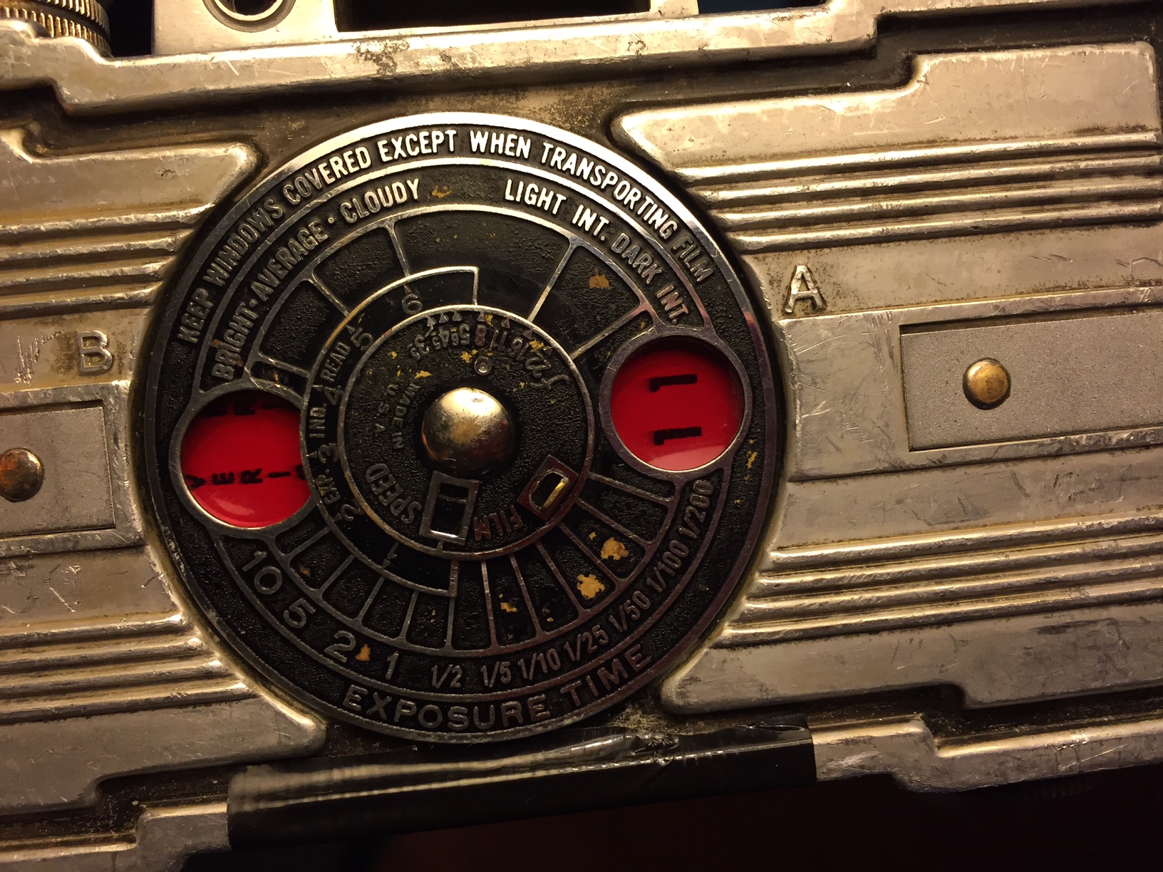 This is a 50-year-old roll of Kodak Verichrome Pan film, set to shot one. When the "1" is advanced to the left window, that will be shot two. Then when the "2" is advanced to the right window, it will be on shot three. The plastic of these windows were always red like the red of darkroom safe lights, but with modern panchromatic film (what the "Pan" in Verichrome Pan is short for), the tint doesn't really matter since modern film picks up red light frequencies as much as any other color. Some black duct tape can be seen over the bottom of the pop-off aluminum backing - I was getting minor light leaks.