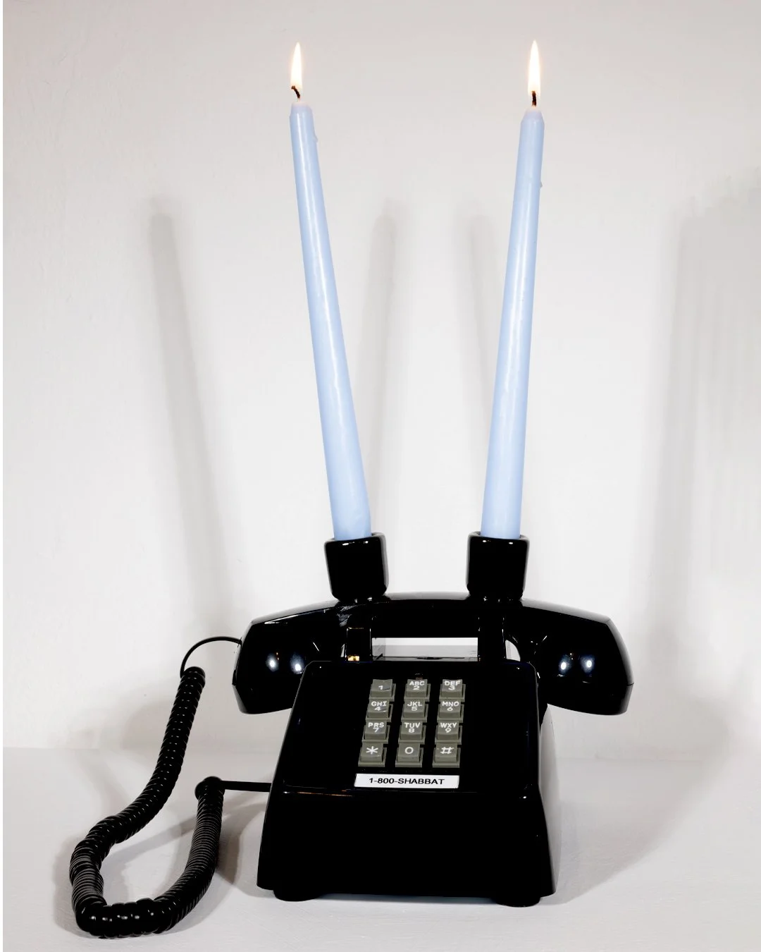  THE 1-800-SHABBAT PHONE  (black edition)  9.12 x 7.26 x 4.67 inches  Acrylonitrile Butadiene Styrene (ABS)+Metal Base  Ceramic candle holders  2026 