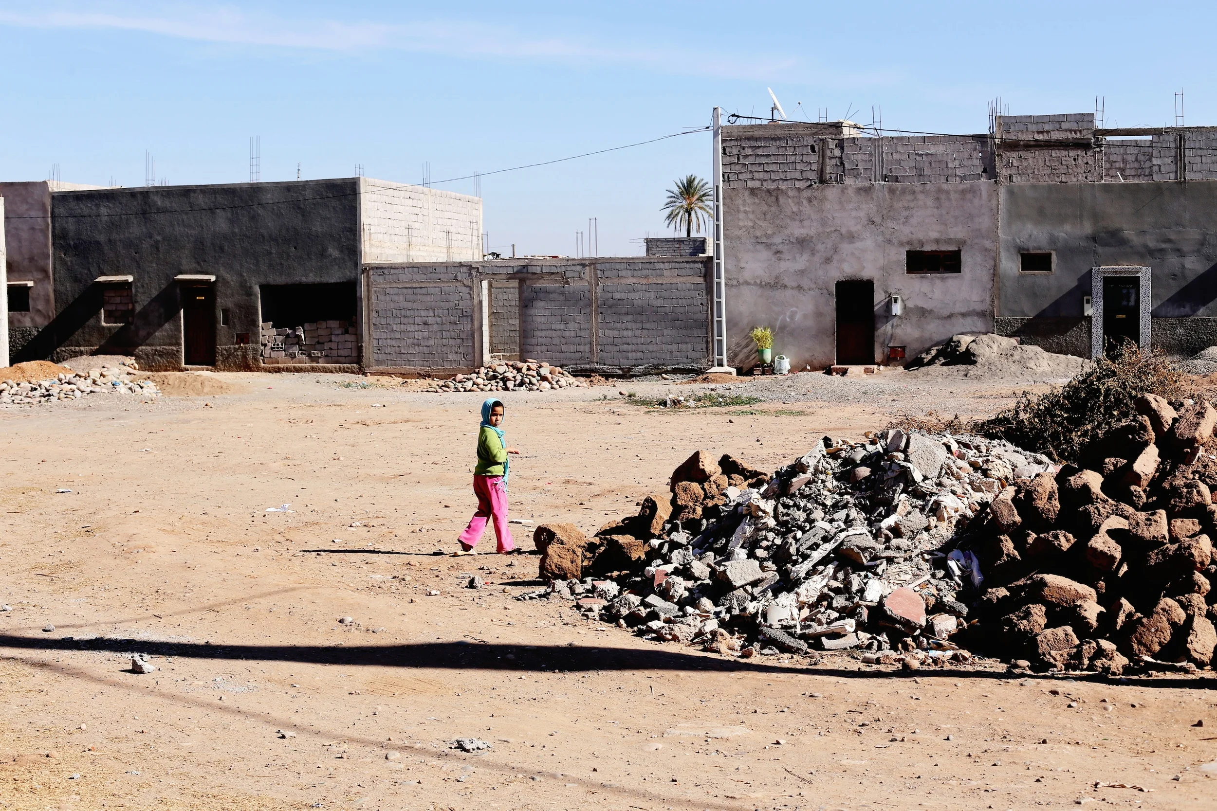 A little girl plays in the rubble of the small village of Douar Ladaam. 