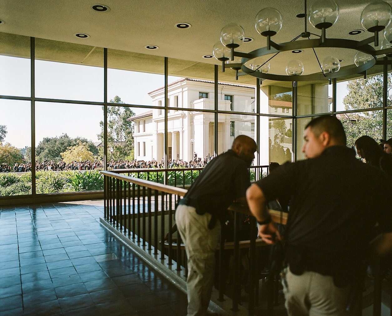 Campus Safety officers look on as students move the protest into the Administrative Center. 