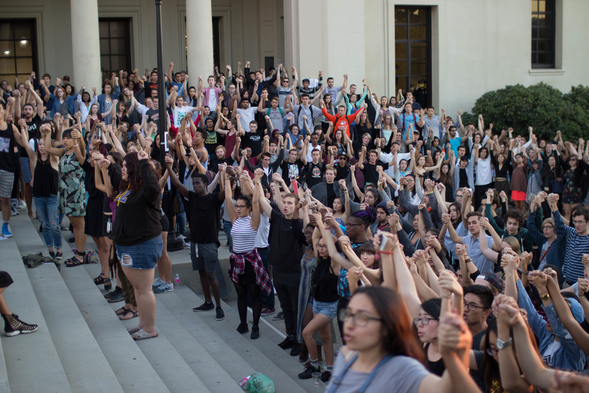 Students lift each others arms as they recite quotes from activist Assata Shakur.