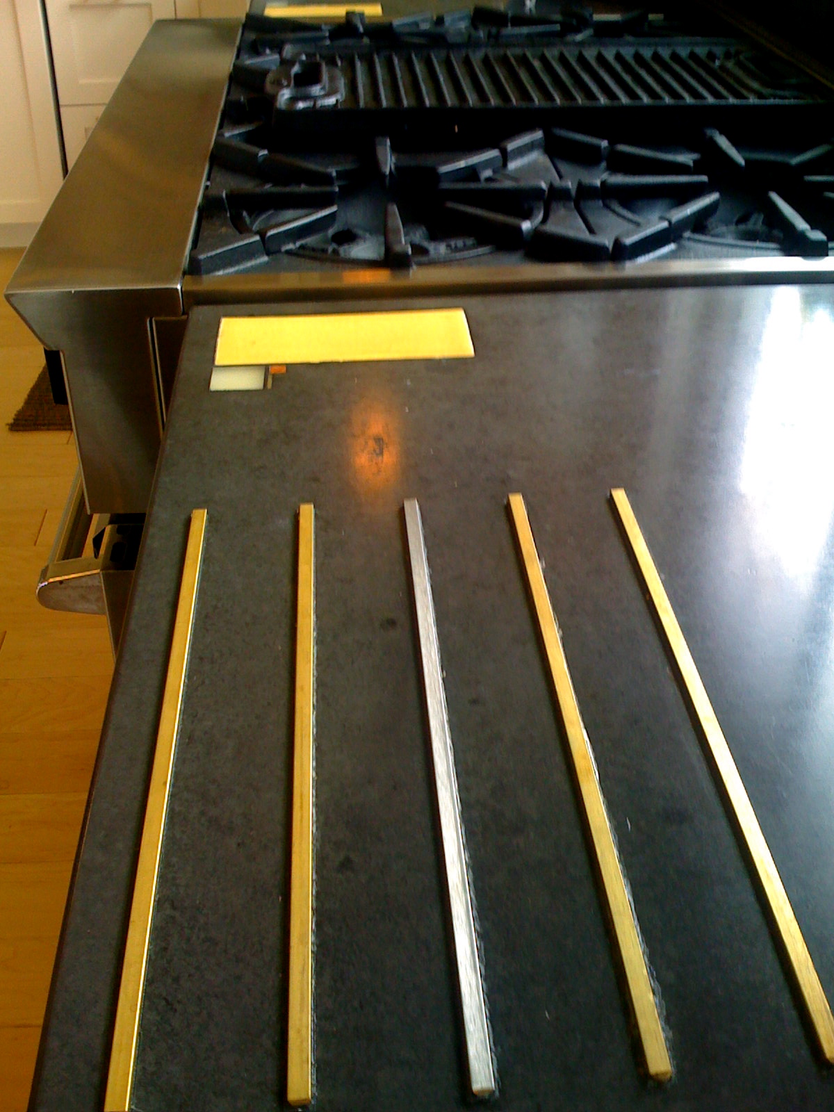 Concrete counter with custom stone and glass inlay