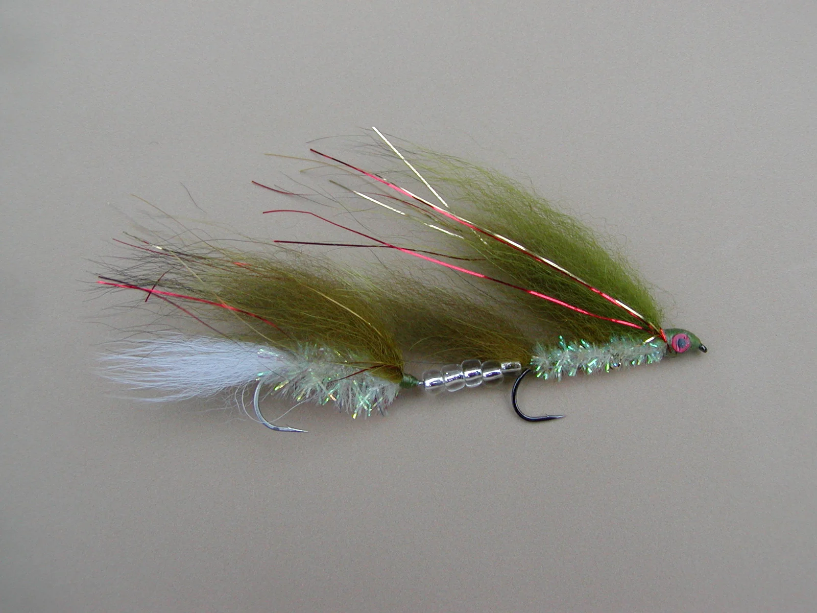 TANDEM TUI CHUB ARCTIC FOX TROLLING FLY #2 The tui chub is a common bait fish in the high desert lakes of the Western USA. This same color scheme is common to many fish living in a weedy environment such as bass and walleye. This is my "Go To" trolling fly for large cutthroat trout in Pyramid Lake Nevada on sunny days. When trolled behind an Action Disc it is effective long lined near the surface or and any depth on a down rigger.
