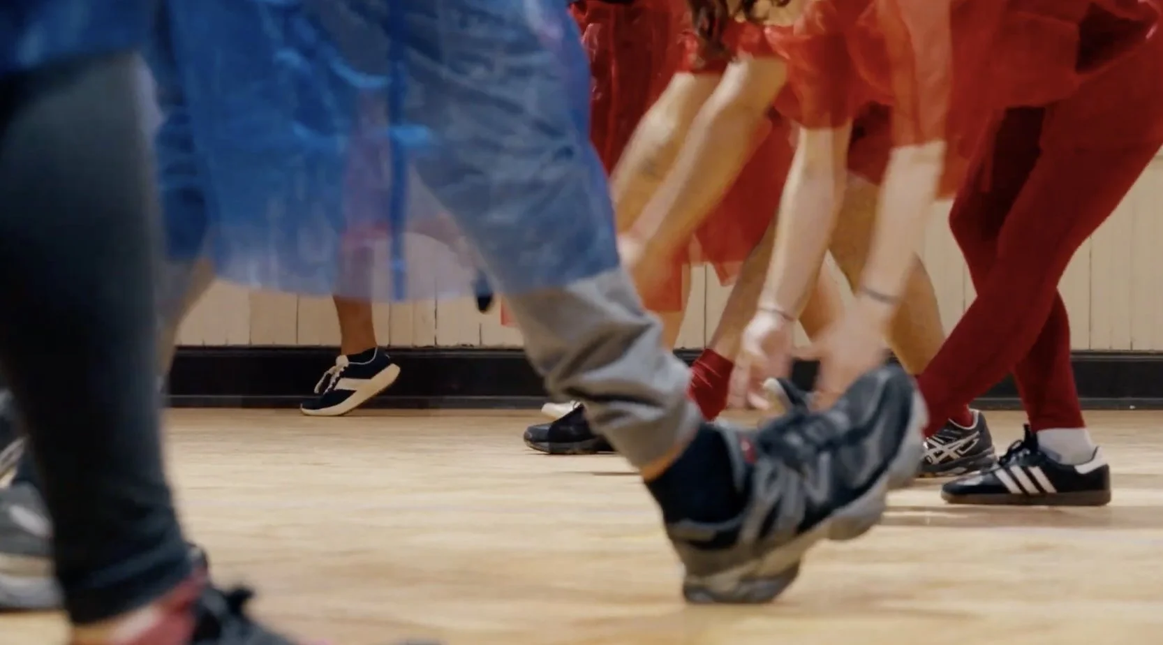  Film still from Milking it, a basketball ballet performance. Handmade red and blue organza costumes.  Video by Bob. Performers: Jan Brugger, Michael Cuadrado Gonzalez, Eli Greene, Jenny Harris, Courtney Mackedanz, Fabien Maltais-Bayda, Mandela, Liz 
