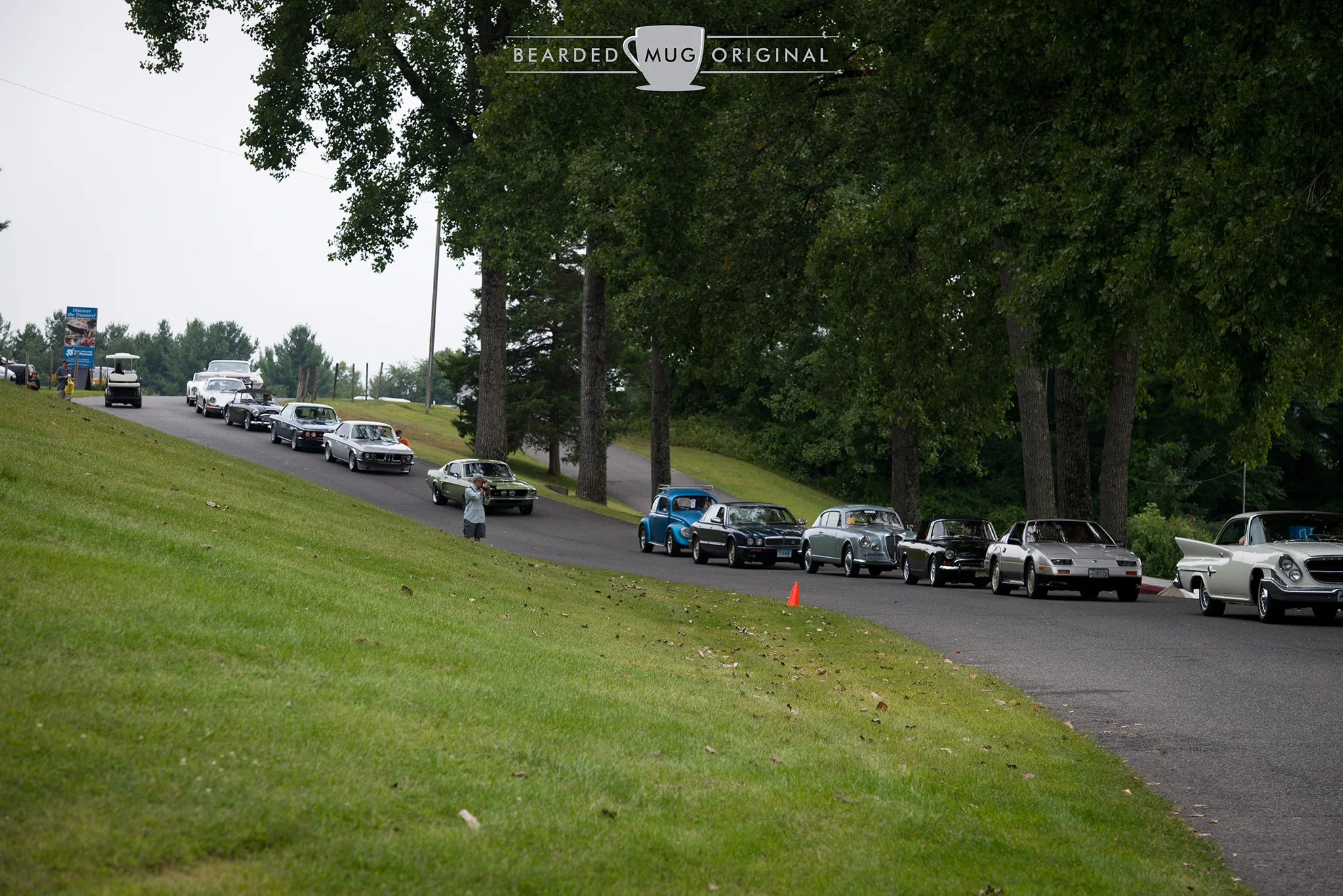 Automobiles in no particular order file down into the infield for the Sunday in the Park show. As you can see, the mix was varied, with Japanese, Germans, Brits and Americans joyfully rubbing bumpers.