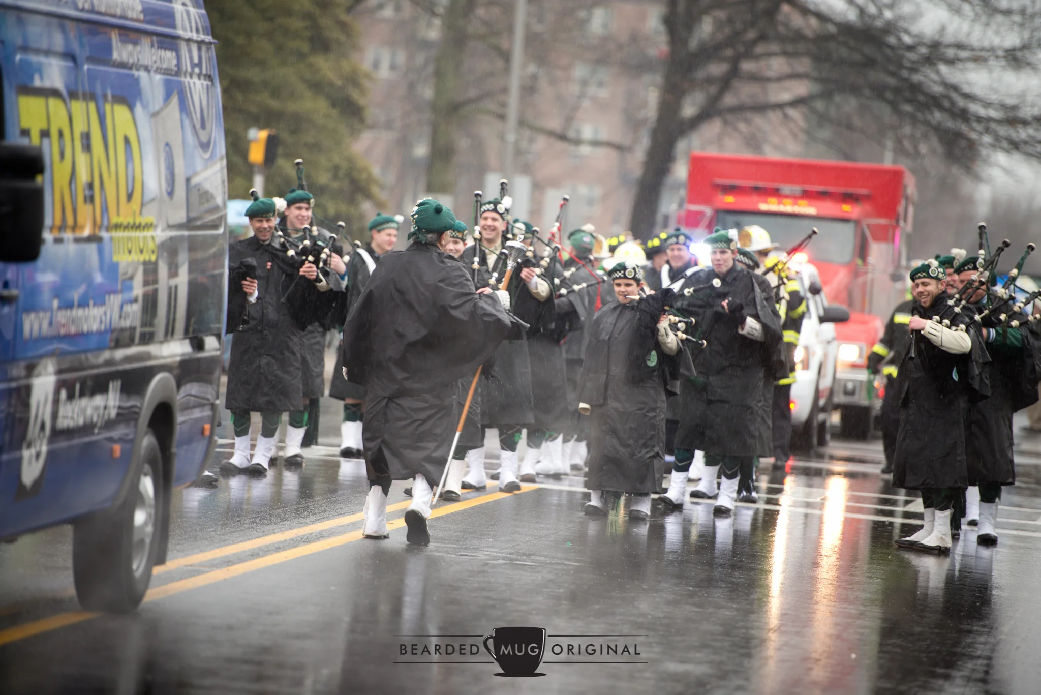 Waterproof your pipes: the bagpipers of the American Weldry Band won't let the soggy weather drown out their sound, or their smiles.