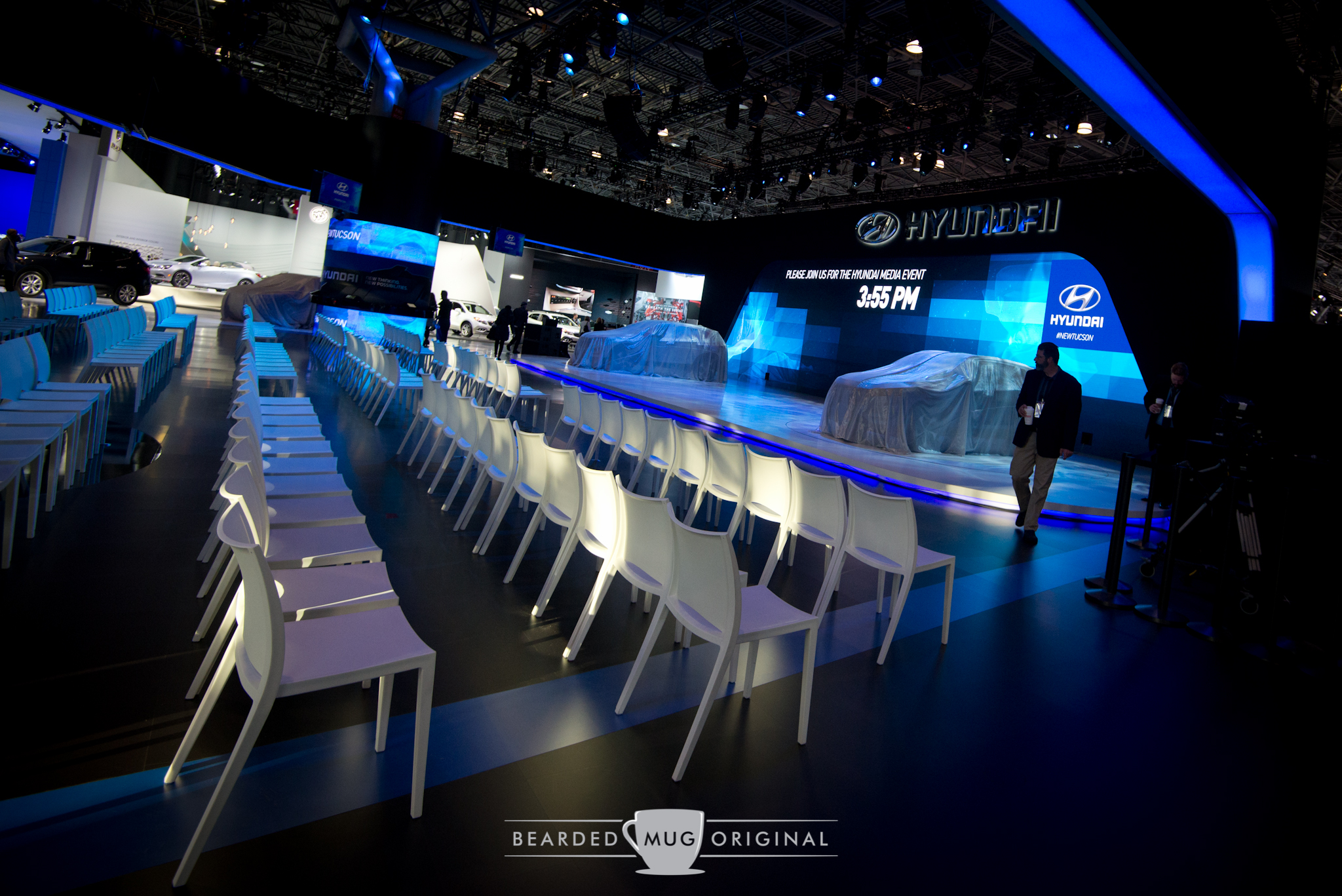 Hyundai's area remained vacant until the indicated time, with new SUVs covered by cloths on the stage.