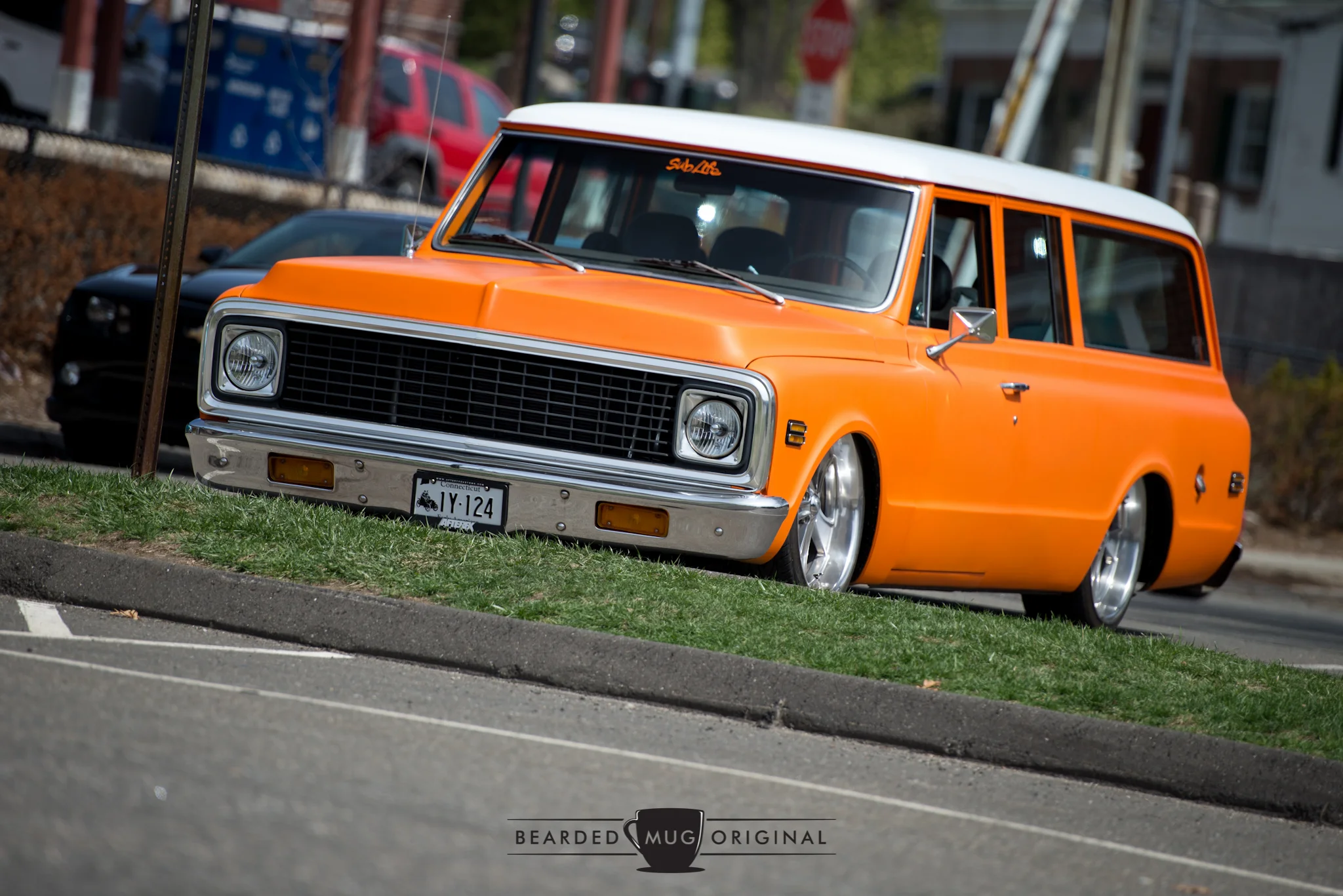 Sometimes it takes that second or third look to realize that this orange Suburban is missing its rear doors.