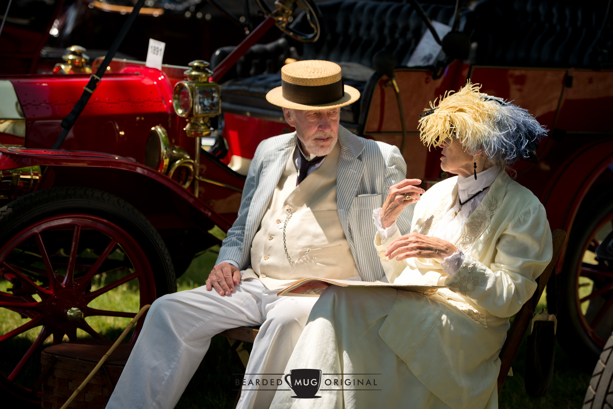 In similar fashion to other prominent shows, some attendees really dressed the part to match their Brass Era rides. You can't see it, but the publication on her lap isn't exactly the current Daily News .
