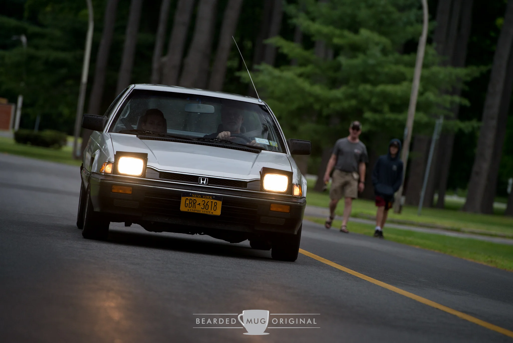 The pop-up headlights of this 1984 Honda Prelude cut through the morning fog that was accompanied by light rain. The Japanese sport coupe was shown in the Driveable Dream class.