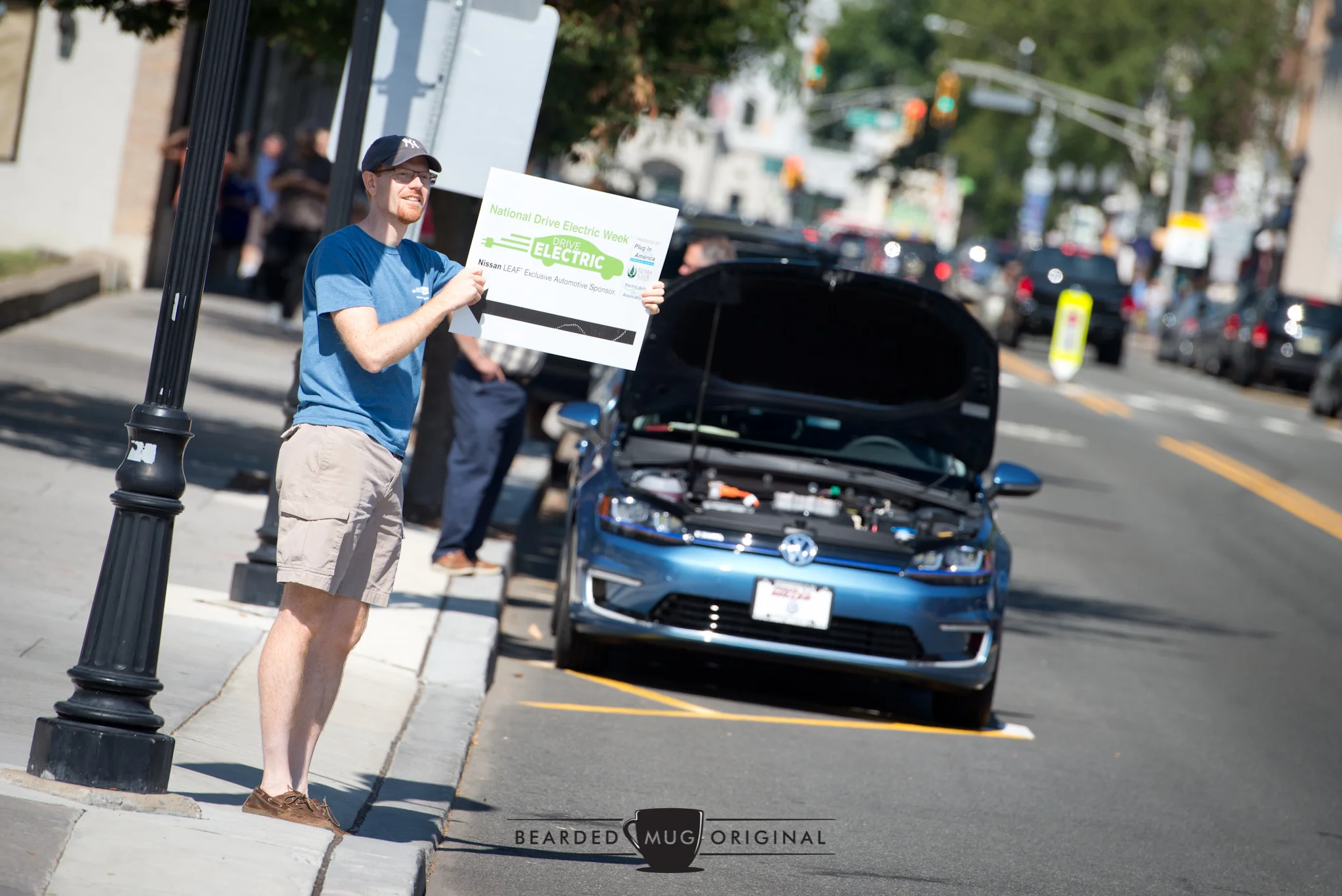 Alex was doing a fine job of enticing passers-by to experience electric cars and take a drive in the Volkswagen e-Golf (background).