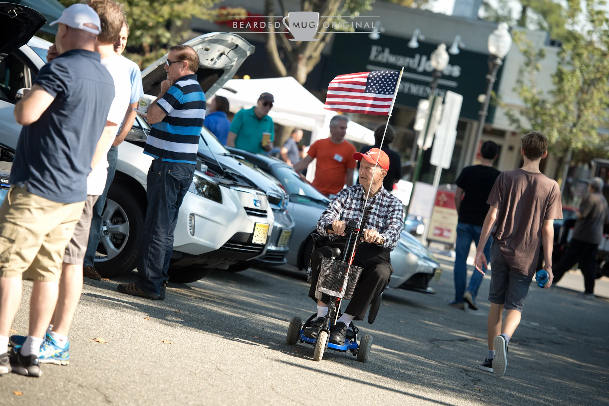 A unintentional tip of the hat: electric cars being enjoyed from an electric scooter.