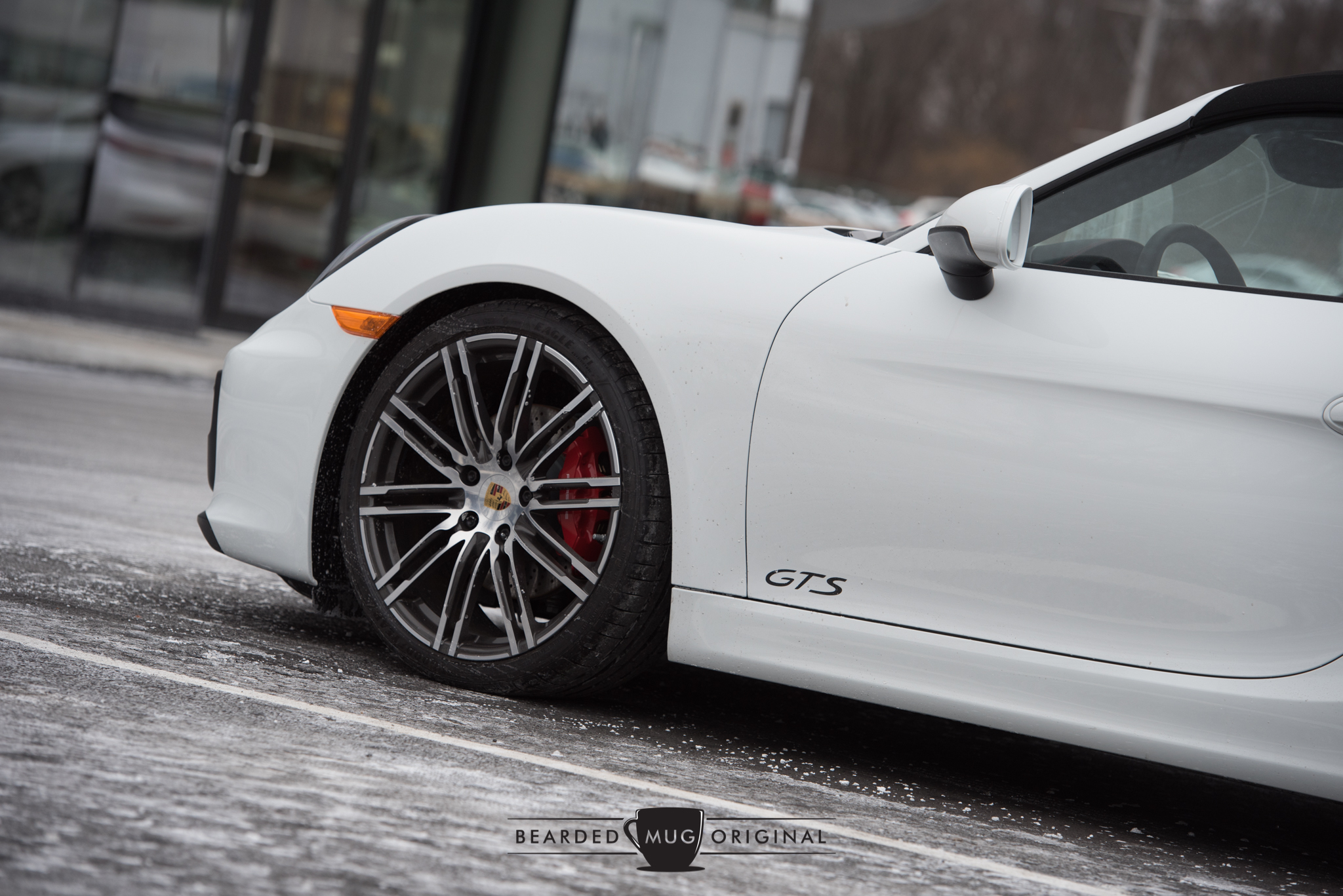 The Boxster GTS, devoid of color with the exception of the red brake calipers, appears to be frozen to the ground.