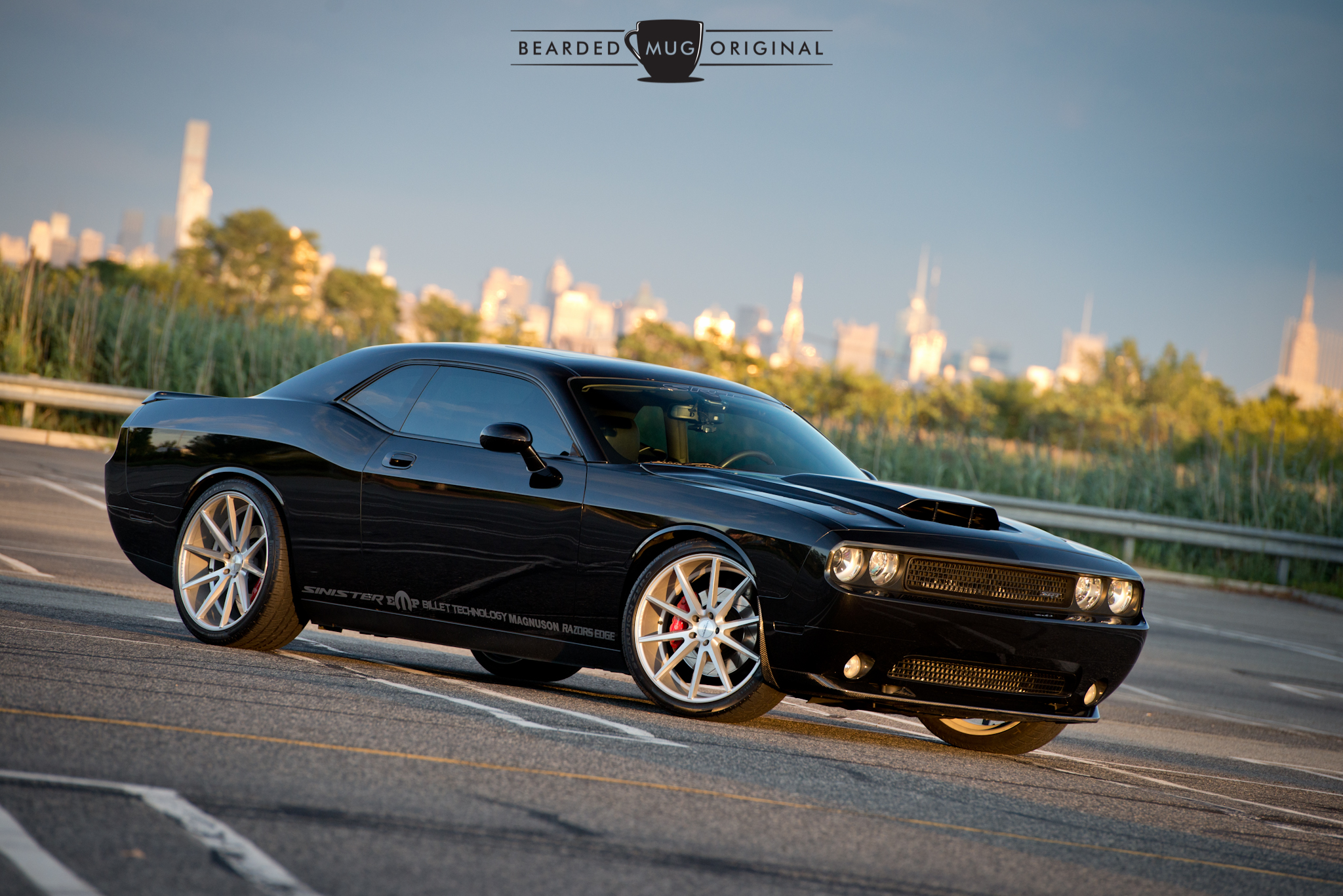 Nothing like a sleek, black muscle machine set in front of a sunlit city skyline.
