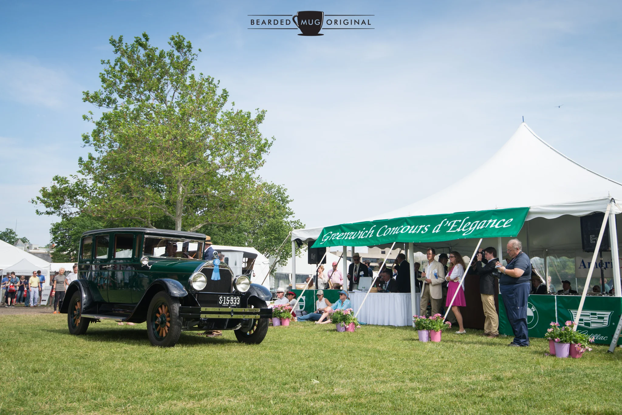 The sun shone brightly during the Americana awards ceremony. Here is a 1928 Locomobile 8-80 collecting its trophy for being the craziest car in attendance. That award name may not be accurate.