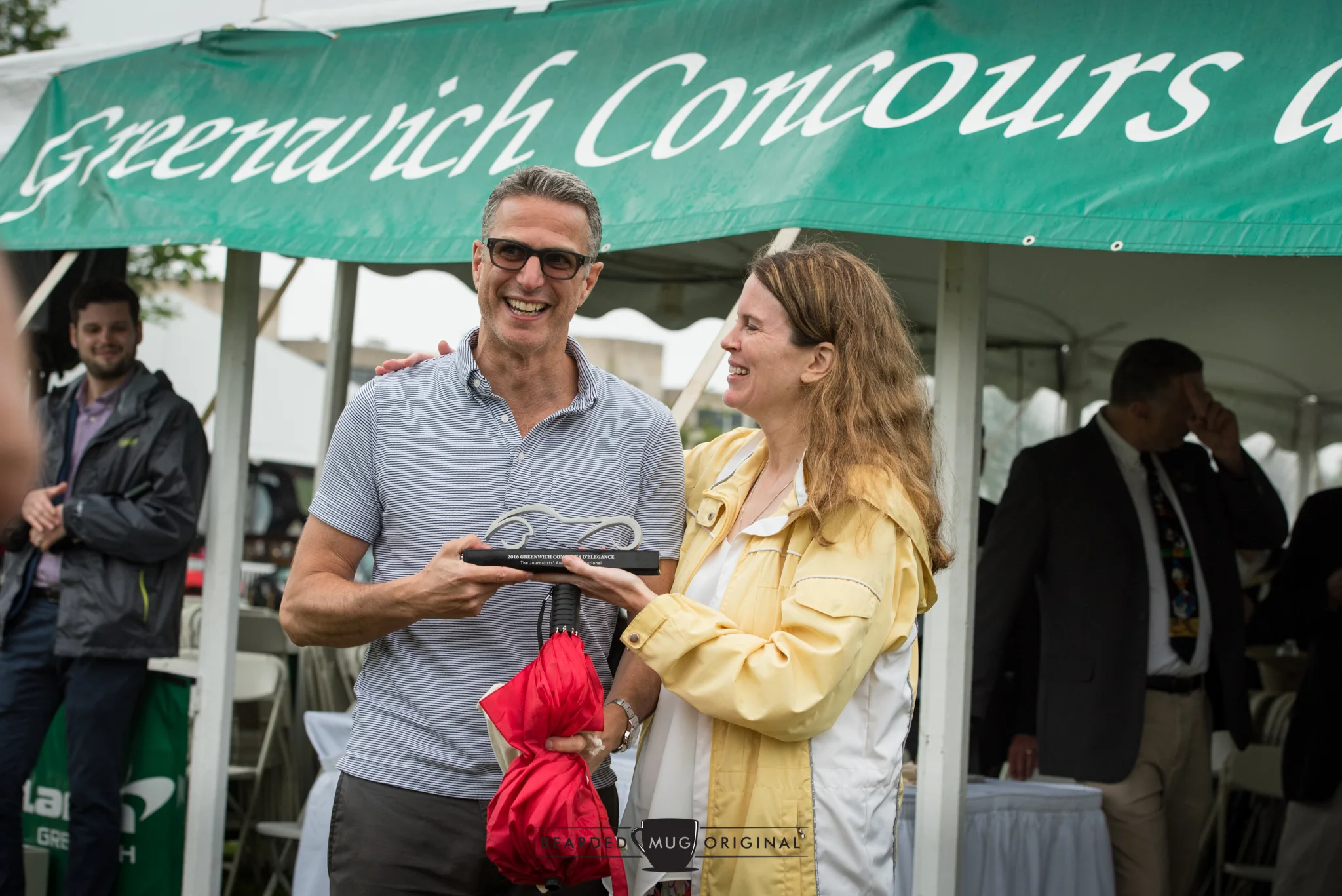 Mary Wennerstrom shares a laugh with double-fisting winner Phil Toledano, who brought home the Journalists' Award for his 1980 Porsche 924 Carerra GTS Clubsport Coupe and the Homologation Special honor for his 1982 Lancia 037. 