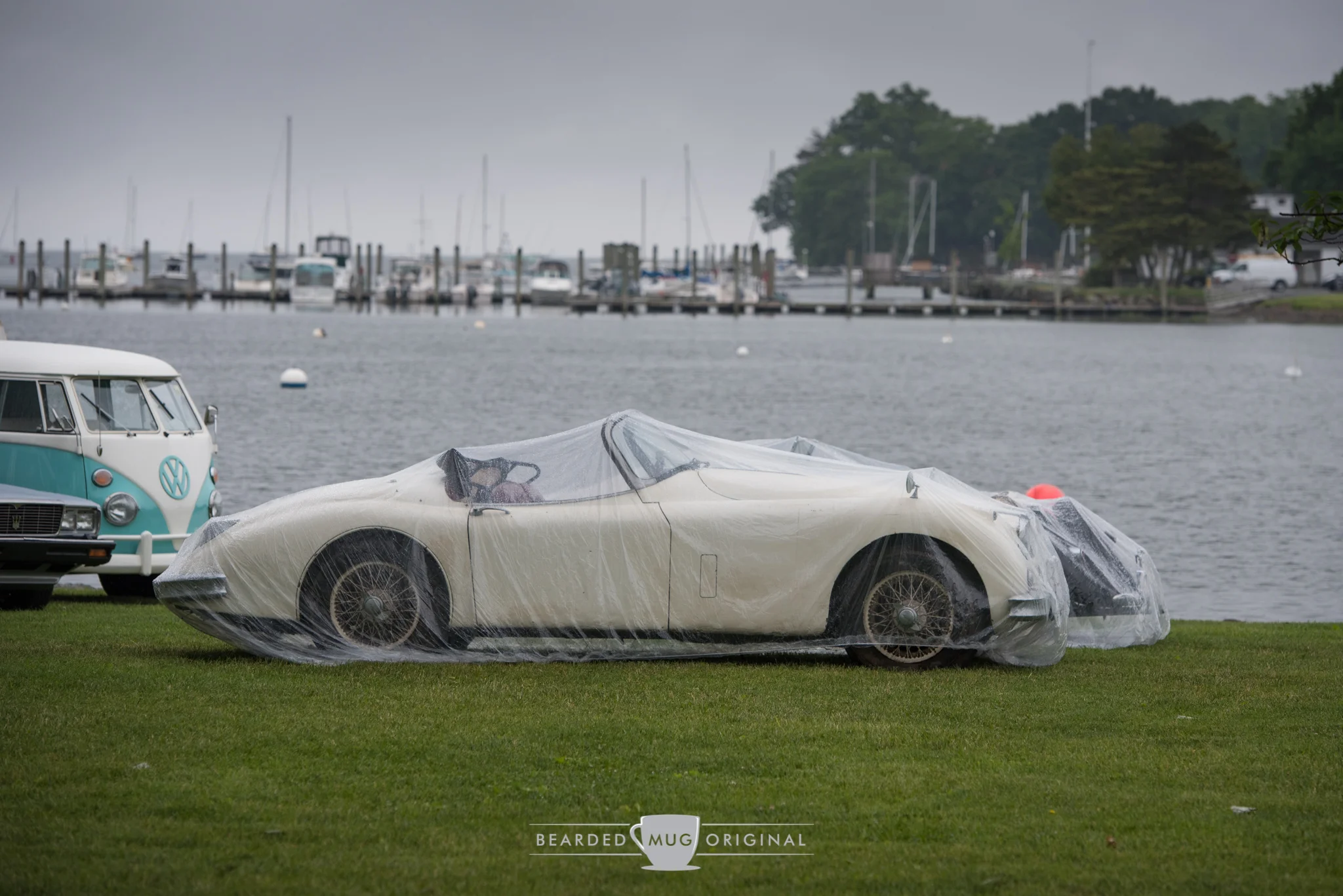 Friday's rain resulted in many of the auction automobiles being covered in what can only be described as shower caps for cars.
