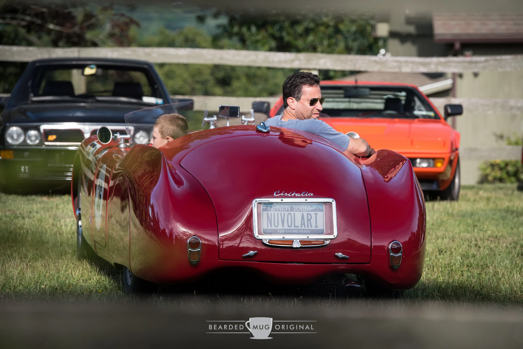 A 1947 Cisitalia 202 SMM "Nuvolari Spider" is a legend amongst legends, as indicated by the BMW M1 and Lancia Delta Integrale Evoluzione parked across the field.