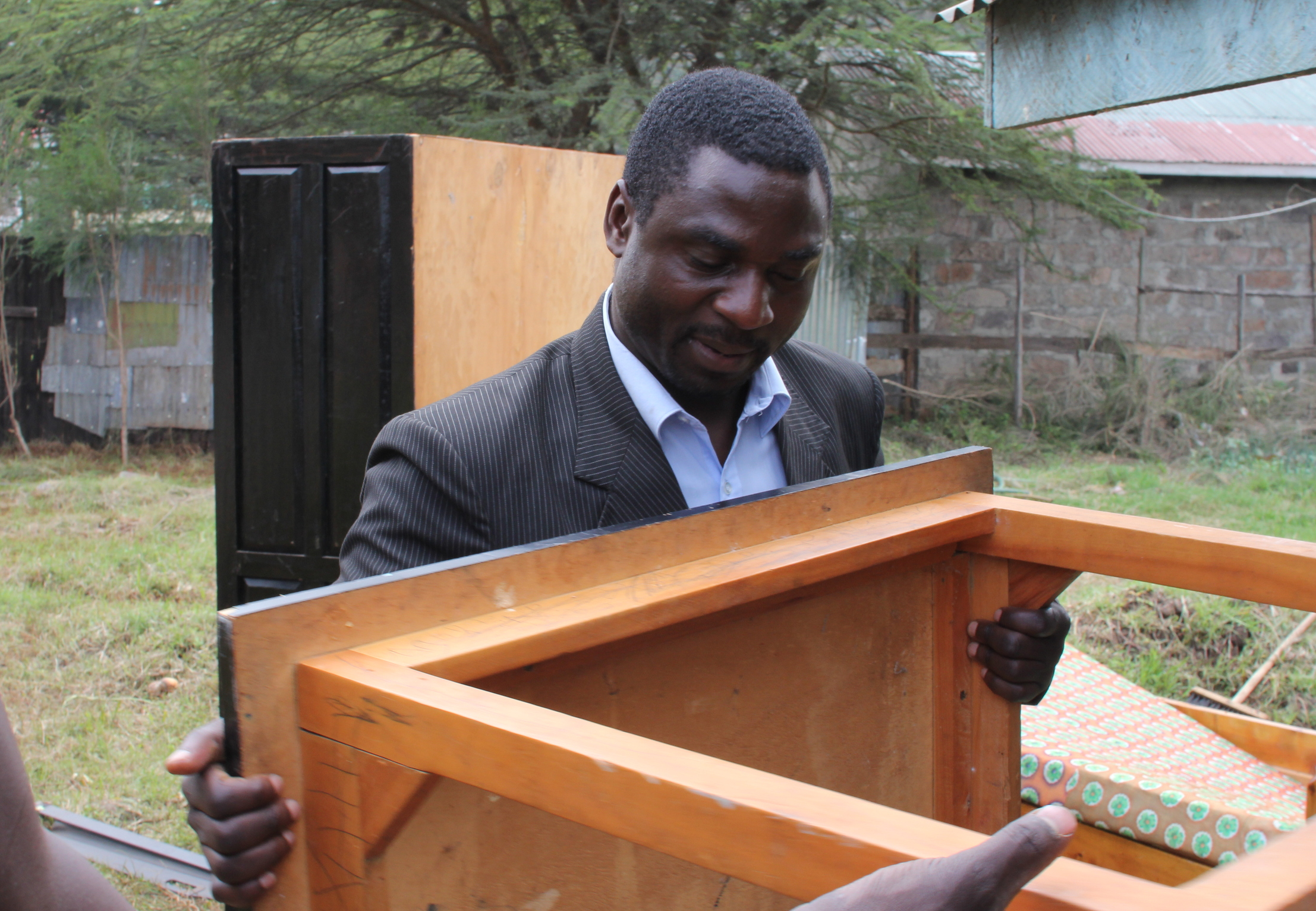 Pastor Shigonde moving furniture and leading the development of the land