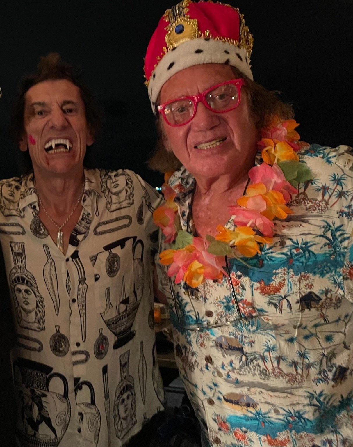  This photo is a celebration at a Halloween party with Dickie on the right and guitarist Ronnie Woods on the left. 