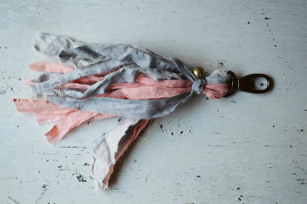 grey and peach tassel clip by Untold Imprint.