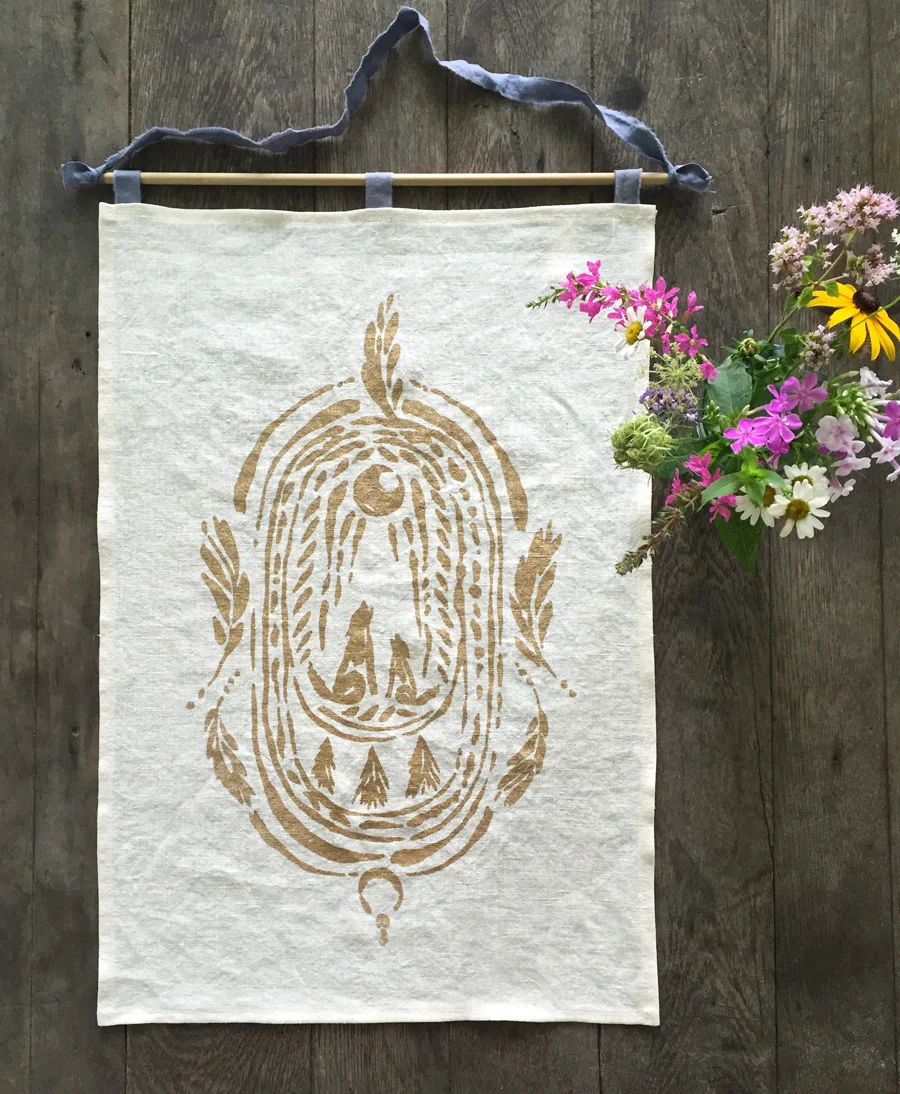 Wild Altar banner with mama wolf & pup, feathers, and evergreen trees