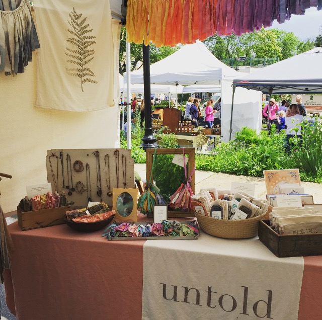 Untold Imprint shop at an outdoor market.