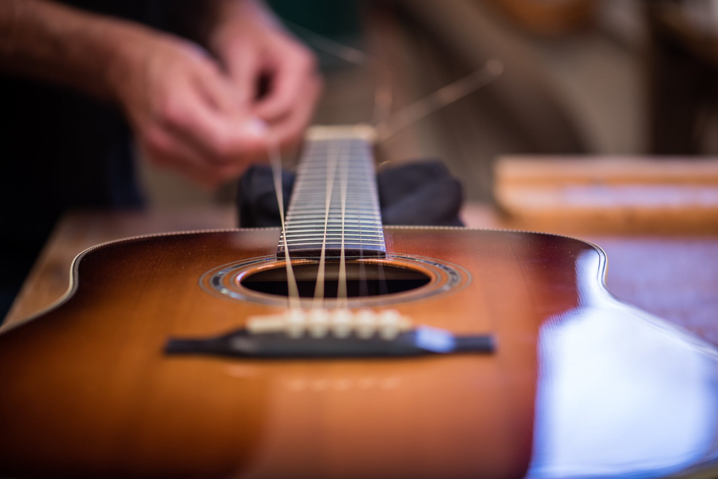 Luthier adds strings to custom acoustic guitar