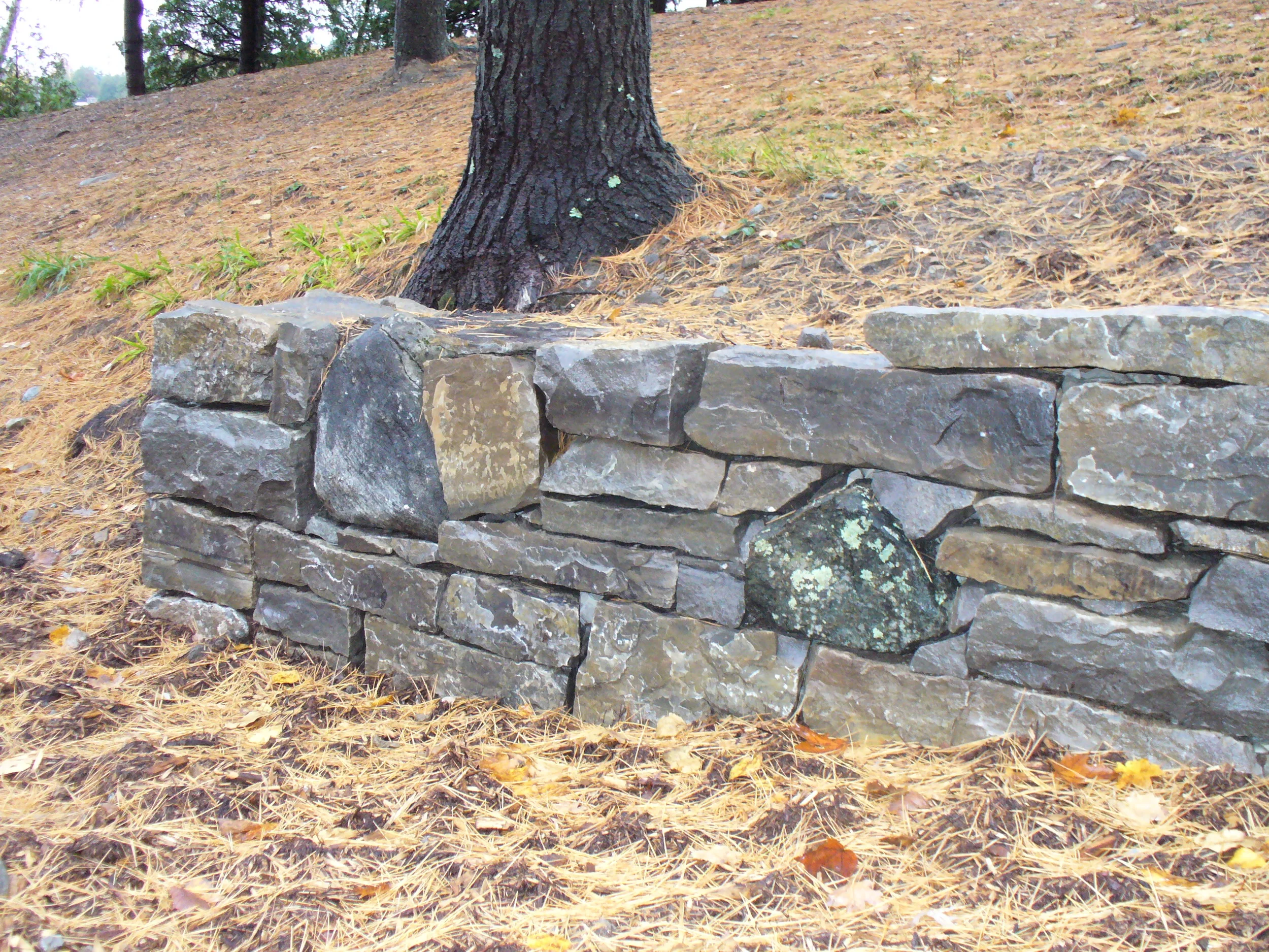 Field stone wall mixed with granite boulders for a custom rustic look