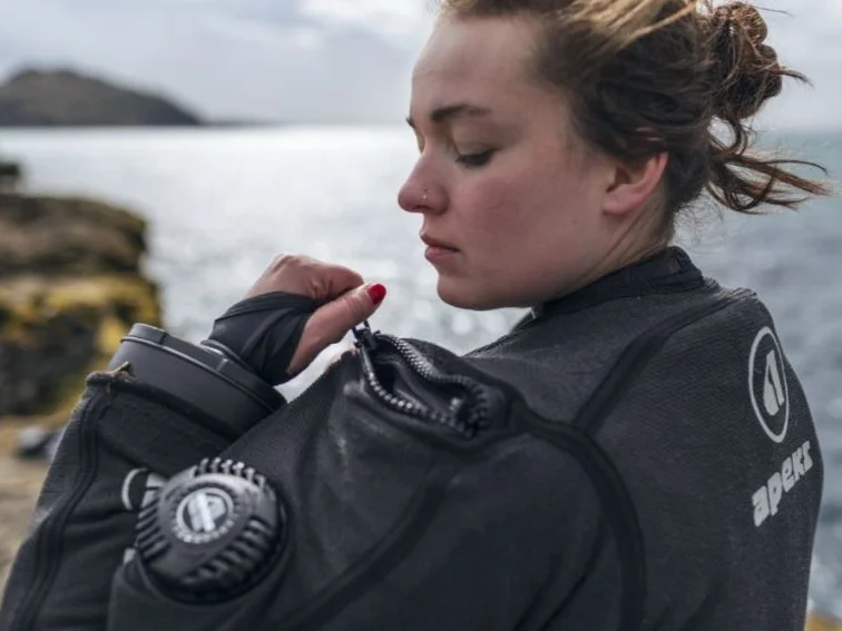 A Drysuit is a sealed layer worn when scuba diving instead of a wetsuit to keep you warm in colder water. It works by trapping a layer of air within the suit which acts as an insulatotor and also helps with your bouyancy. Your body stays dry underneath the drysuit and you can also wear thermals to stay even warmer. In British Columbia, the vast majority of divers will use a Drysuit for diving. To use a Drysuit, you have to complete a certification course, the PADI Drysuit Specialty. This course will teach you important safety skills and can be taken with Rowand’s Reef. Without a Drysuit Certification you arte unable to rent or use a drysuit. You don't have to use a drysuit if you don't want to however! For those who aren't as interested in Drysuit diving, we have warm 7mm J-Type Wetsuits available for use in the ocean. These wetsuits will keep you warm in the cold waters for most part of the year and can be requested in place of the drysuit for use on your course. At Rowand's Reef, we carry the Aqua Lung Fusion Range of Drysuits. These suits contain the latest in drysuit technology and allow for a customized fit with added flexibility and bouyancy control in the water.
