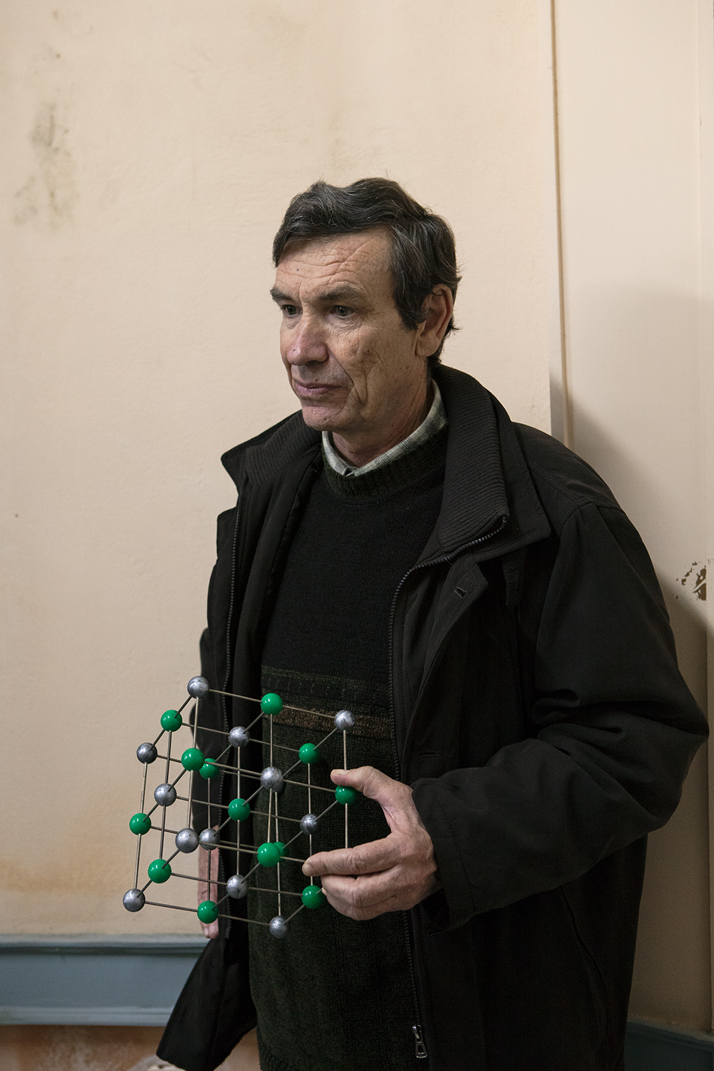  Physics teacher holding a model of crystal salt.&nbsp;A large part of the school environment has been formed by people deeply devoted to their profession, almost like having a love affair with their job. 