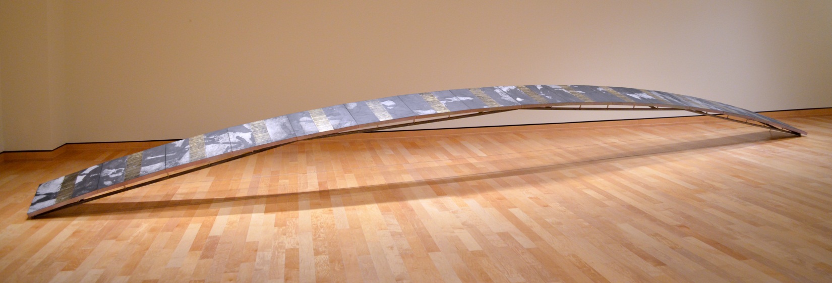 Arc woodcut and collographic printed images on paper, mounted on constructed panels, installed on an arc-shaped steel structure. ink, paper, metallic foil, wood, steel 384" x 24" x32" (32’ x 2' x 32") 2012 The power of simple geometry is becoming a fundamental part of my sculptures. Breaker , Pusher and Balancer display this aspect overtly. In fact, Arc is an echo of Balancer’s inverted arc. The low broad segment of a much larger circle gives this structure a feel of continuation. I felt very strongly that the curve of Arc was exactly circular, and not a reversed catenary curve (a catenary is a curve described as a line suspended between two points, such as a power line or the main cables of a suspension bridge). A catenary has two definite end points while a segment of a circle does not. 