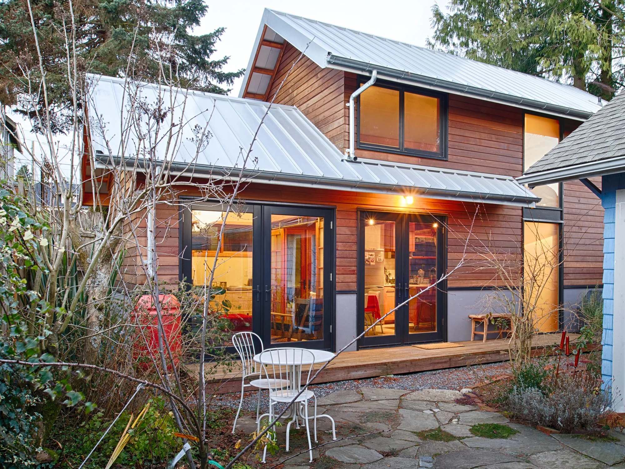 A rustic backyard art studio and guest house constructed with extensive use of recycled building materils and reclaimed fir structural members