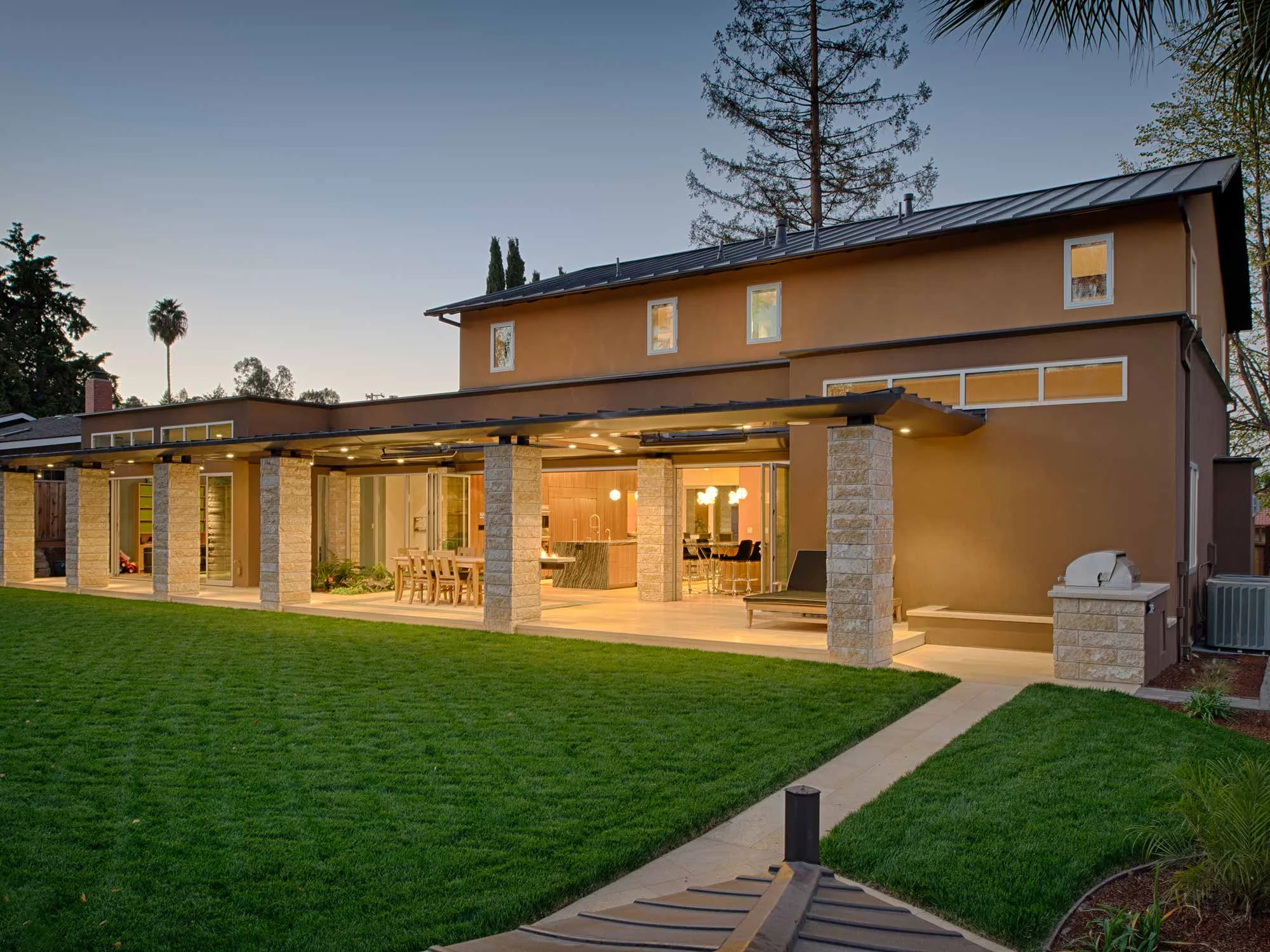The house features seamless indoor/outdoor living with gardens and terraces linking the house to the landscape. 