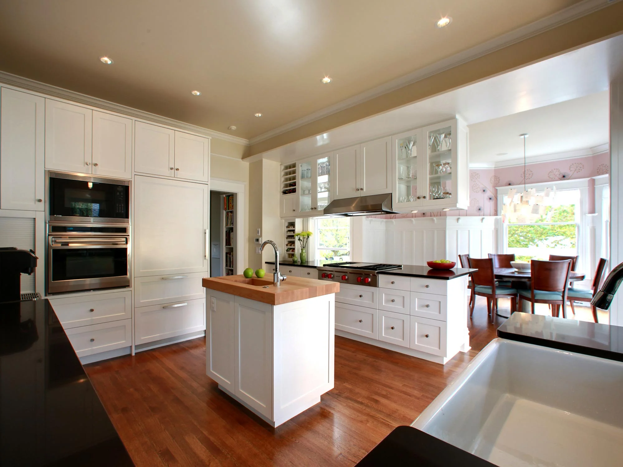The complete remodel of this classic 1906 Capitol Hill home involved enlarging and opening the kitchen, adding a back porch, a bath remodel, finishing the basement, and new landscaping.
